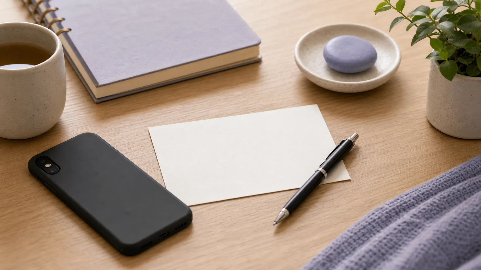 Blank response card beside a phone face down before replying to an ex